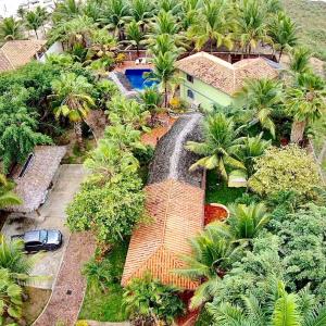 an aerial view of a house with palm trees at CanoaOasis in Canoa