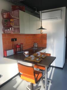 a kitchen with a table and two chairs and a counter at la kischte vintage in Colmar