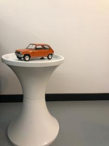 a small toy car sitting on top of a white table at la kischte vintage in Colmar
