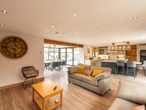 a living room with a couch and a table at Granar in Derwen