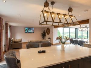a kitchen and living room with a large table and chairs at Granar in Derwen