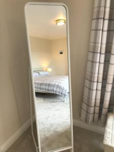 a mirror in a bedroom with a bed at Twizell Lane in Beamish