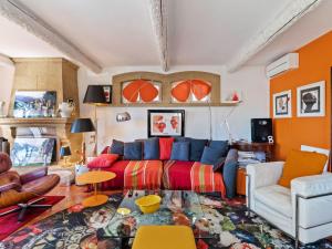 a living room with a couch and orange walls at Scenic villa in Martigues with private pool in La Couronne