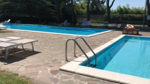 a swimming pool with a table and a bench next to it at WHITE HOUSE in Brescia