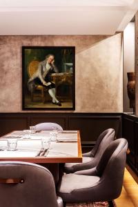 a dining room with a painting of a monkey sitting on a table at Radisson Blu Hotel, Madrid Prado in Madrid