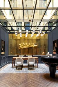 a rendering of a lobby with a table and chairs at Radisson Blu Hotel, Madrid Prado in Madrid