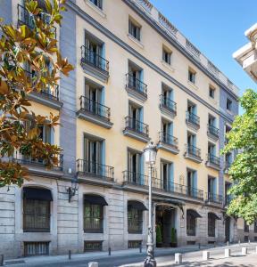 a large building with balconies and a street light at Radisson Blu Hotel, Madrid Prado in Madrid