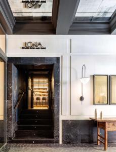 a lobby of a store with a staircase and a table at Radisson Blu Hotel, Madrid Prado in Madrid