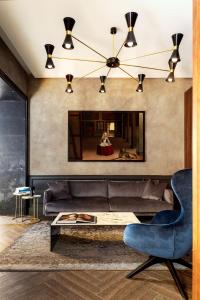 a living room with a couch and a table at Radisson Blu Hotel, Madrid Prado in Madrid