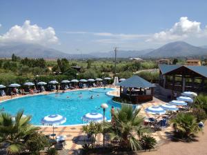a large swimming pool with umbrellas and people in it at Hotel San Gaetano in Grisolia