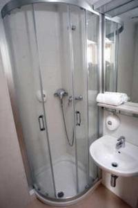 a bathroom with a shower and a sink at Hospedería San Martín Pinario in Santiago de Compostela