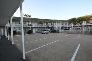 a parking lot in front of a large building at Colonial Rose Motel in Townsville