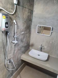 a bathroom with a shower and a sink at Baanrimdoi Resort Lampang in Lampang