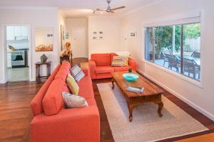 a living room with two orange couches and a coffee table at Swell Shack in Dunsborough