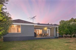 a small white house with a yard at Swell Shack in Dunsborough