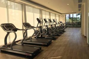 a row of exercise bikes in a gym at Cozy modern room with stunning lake & mountain view in Chiang Mai