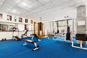 a gym with several exercise equipment in a room at Санаторий Адлеркурорт корпус Коралл in Adler