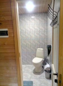 een badkamer met een toilet in een kamer bij Guest House Pītagi in Košrags