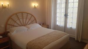 a bedroom with a large white bed and a window at Hôtel de Charme Brise Marine in Saint-Jean-Cap-Ferrat