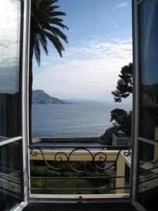a view of the ocean from a window at Hôtel de Charme Brise Marine in Saint-Jean-Cap-Ferrat