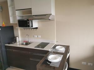 a kitchen with a counter with two plates on it at APARTMENTS MBC in Mai Khao Beach