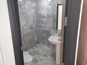 a bathroom with a toilet and a sink at APARTMENTS MBC in Mai Khao Beach