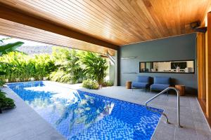 a swimming pool in the middle of a house at Aqua - at Funnel bay in Airlie Beach