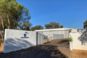 a gate in front of a building with trees at Casa del Príncipe in Daimiel