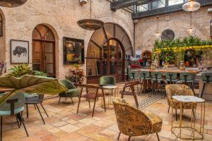a restaurant with tables and chairs and a bar at Alegra Boutique Hotel in Jerusalem