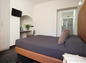 Posteľ alebo postele v izbe v ubytovaní Borgo Pio Suites Inn