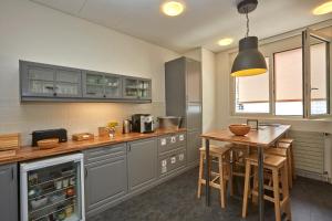 a kitchen with a table and a counter in it at Les Chambres du CTN in Geneva +34 photos