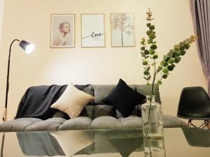 a living room with a couch and a glass table at Skypod Residence Puchong in Puchong