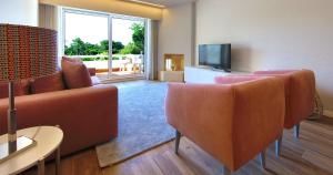 sala de estar con sofá, sillas y TV en Victory Village 18E en Quinta do Lago