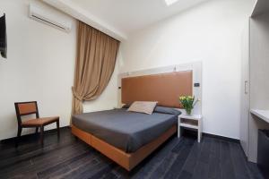 Posteľ alebo postele v izbe v ubytovaní Borgo Pio Suites Inn