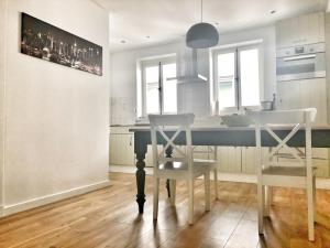 a kitchen with a table and two white chairs at Haus Hermine in Cochem