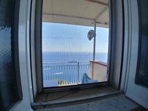 a window with a view of the ocean from a balcony at GIARDINO SUL MARE in Amalfi