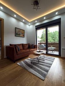 a living room with a couch and a table at Apartman Relax Lux - Vila Peković in Zlatibor