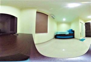 a waiting room with a couch and a tv at Giant Kost in Tangerang +17 photos