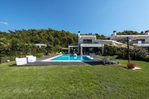a house with a swimming pool in a yard at Possidi Villa Glamour by Luxlikehome in Possidi