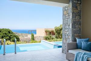 a view of a swimming pool from a villa at Daios Cove in Agios Nikolaos