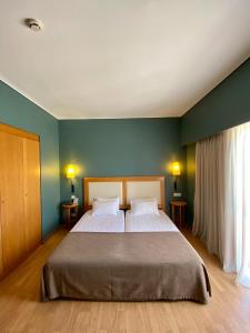 Postel nebo postele na pokoji v ubytování Olympic Hotel