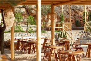 a group of tables and chairs under a pavilion at Daios Cove in Agios Nikolaos
