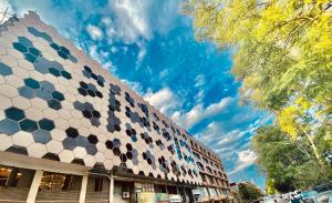a building with a hexagonal pattern on the side of it at Shelton's Ambassador in Islamabad