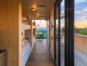 a house with a balcony with a view of the ocean at BERGHEIM Container Loft in Schöneck