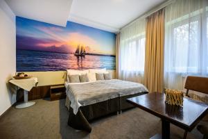 A bed or beds in a room at Hotel U Šuláka