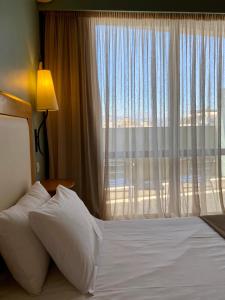 Postel nebo postele na pokoji v ubytování Olympic Hotel