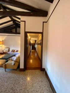 a hotel room with two beds and a hallway at Cà Francesco Apartment in Venice