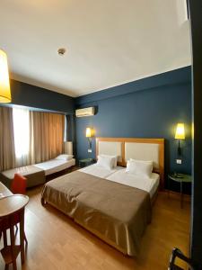 Postel nebo postele na pokoji v ubytování Olympic Hotel