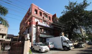 a truck parked in front of a building at HOTEL VEER PALACE By GREYSKY NEAR AIIMS DELHI in New Delhi