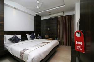 a bedroom with a large bed with a red sign on it at HOTEL VEER PALACE in New Delhi +4 photos